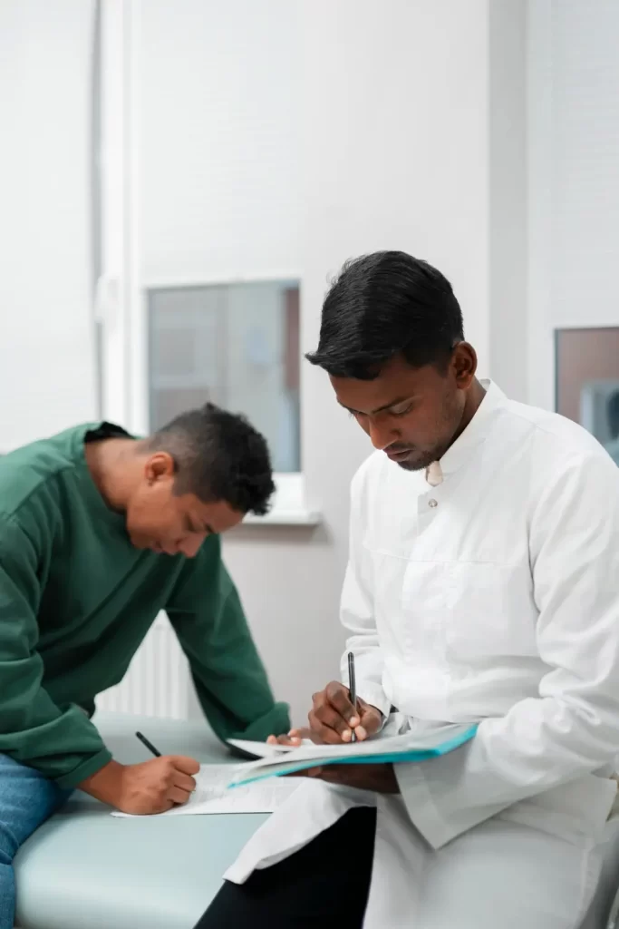 Doctor assisting a patient with medical forms during alcohol detox consultation at Alcohol Detox London.