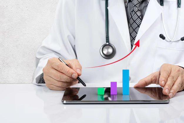 Doctor reviewing patient recovery progress on a tablet, representing improved health outcomes through Alcohol Detox London’s treatment programs.