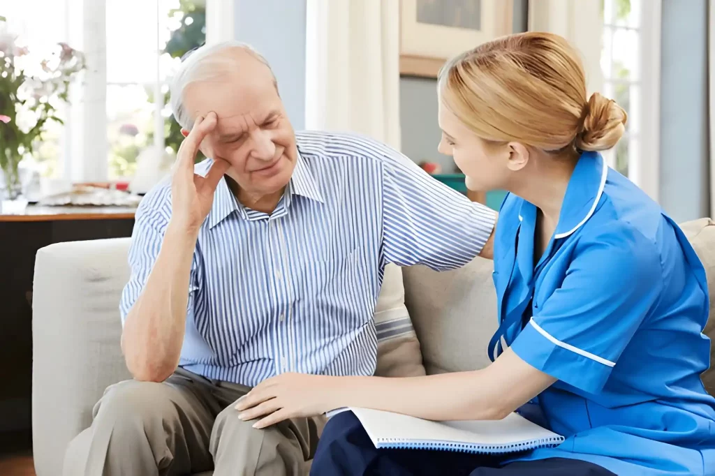 Nurse comforting an elderly man during an in-home alcohol detox consultation, representing compassionate care at Alcohol Detox London.