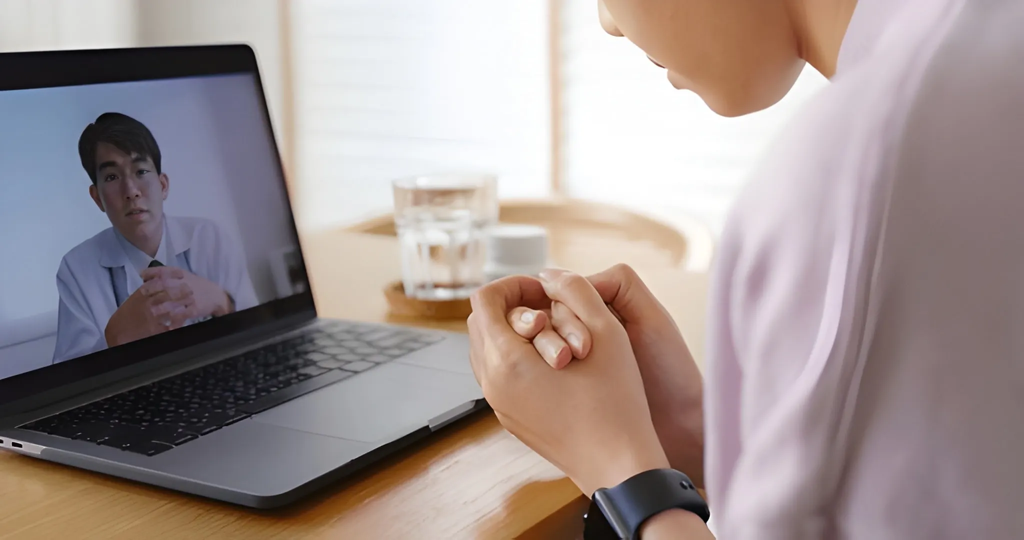 Person having an online alcohol counselling session with a therapist on a laptop, showing Alcohol Detox London’s remote support service.