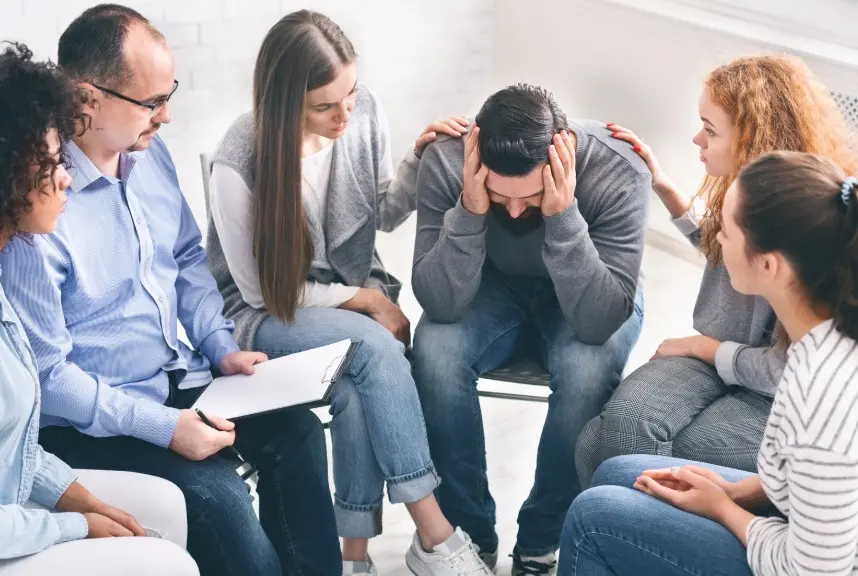 Support group comforting a man struggling with alcohol addiction, representing emotional healing and peer support at Alcohol Detox London.
